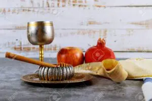 Jewish new year symbol Rosh hashanah with glass honey jar and fresh ripe apples.